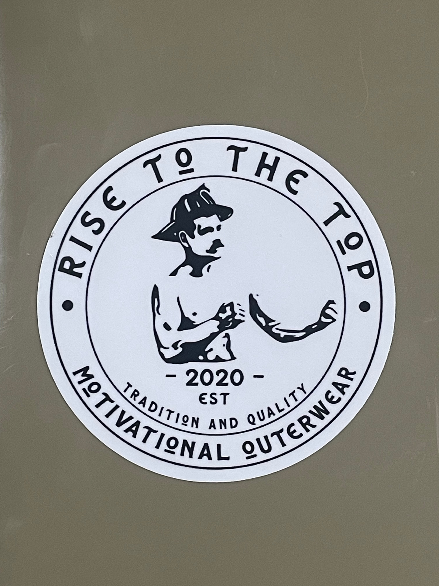 Rise to the top round logo sticker on beige background.